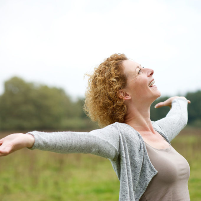 31616441 - close up portrait of a cheerful carefree woman with arms outstretched